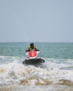 Young handsome jet ski rider in action, moving swiftly on the ocean