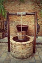 The well. Artesian wells made of brick and wood. Royalty Free Stock Photo