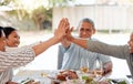 Well always be here to hold each other up. a family giving each other a high five while having dinner together at home. Royalty Free Stock Photo