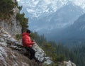 Well built mountain guide having rest at astonishing winter rocky landscape background