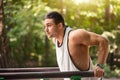 Well built muscular man doing a physical exercise outdoors Royalty Free Stock Photo