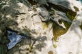 a well carved into the rock by a mountain river, rocks in the carpathians, background, nature Royalty Free Stock Photo