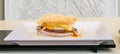 Well cocked sandwich with meet, eggs, cheese with pasta on top Royalty Free Stock Photo