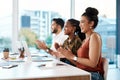 Well done. a diverse group of businesspeople sitting in the office together and clapping. Royalty Free Stock Photo