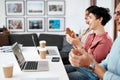 Well done. a diverse group of businesspeople sitting together and clapping after a successful meeting in the office. Royalty Free Stock Photo