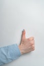 Well done gesture. Female hand holding thumb up on white background. Vertical frame Royalty Free Stock Photo