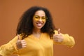 Well done, good job. Waist up portrait of joyful brunette woman showing thumbs up, like gesture to camera and smiling Royalty Free Stock Photo