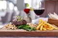 Well-done steak is served with French fries, white bread, grilled white snow mushrooms, asparagus, decorated with alfalfa sprouts