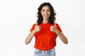 Well done, yes. Smiling satisfied brunette girl shows thumbs up, like and agrees, approves something good, praise and Royalty Free Stock Photo