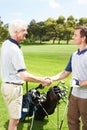 Well done, you played a great game. Golfing partners shaking hands after a game of golf. Royalty Free Stock Photo