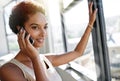 Well double your earnings for you. A young businesswoman talking on her cellphone while standing by her office window.