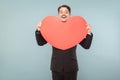 Well dressed adult man holding big red heart and smiling Royalty Free Stock Photo