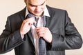 Well dressed business man adjusting his neck tie Royalty Free Stock Photo