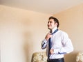 Well dressed business man adjusting his neck tie Royalty Free Stock Photo