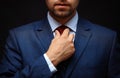 Well dressed businessman adjusting his neck tie Royalty Free Stock Photo