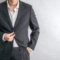 Well dressed businessman in black suit adjusting his jacket. Royalty Free Stock Photo