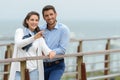 well dressed couple looking out over water from bridge Royalty Free Stock Photo