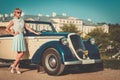 Well-dressed lady near classic convertible