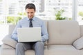 Well dressed man using laptop at home Royalty Free Stock Photo