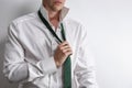 Well dressed man in white shirt get dressed / undressed. Royalty Free Stock Photo