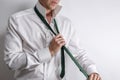 Well dressed man in white shirt get dressed / undressed. Royalty Free Stock Photo