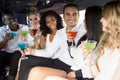 Well dressed people drinking cocktails in a limousine Royalty Free Stock Photo