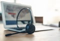 Well get back to you soon. Still life shot of a headset and laptop on table in an office. Royalty Free Stock Photo