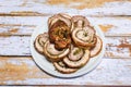 Well grilled porchetta sliced into rounds in a dish and ready to serve