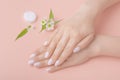 well groomed beautiful woman hands on a pastel background. hand skin care concept