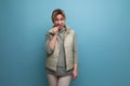 well-groomed blond youthful woman in spring clothes isolated on blue background