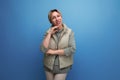 well-groomed blond youthful woman in spring clothes isolated on blue background