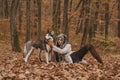 Well groomed husky looks so harmonically with his master. Best friends. Unconditional love. Autumn Girl enjoy walk with