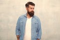 Well groomed macho. Brutal handsome hipster man on grey wall background. Bearded man trendy hipster style. Masculinity