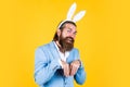 well groomed man in wedding formalwear and bunny ears has beard, happy easter