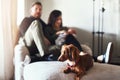 Well hello there. a cheerful young family seated on a sofa together at home during the day. Royalty Free Stock Photo