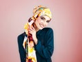 Well hello there gorgeous. Studio portrait of a confident young woman wearing a colorful head scarf while posing against Royalty Free Stock Photo