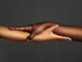 Well hold on to each other forever. Studio shot of two unrecognizable people holding hands against a grey background. Royalty Free Stock Photo