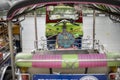 Well known and famous local taxi in Thailand, Tuk-Tuk, parking nearby tourist place, waiting for passengers asking for a ride.