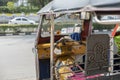 Well known and famous local taxi in Thailand, Tuk-Tuk, parking nearby tourist place, waiting for passengers asking for a ride.