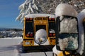 The well-known yellow school bus covered in snow in Vancouver