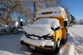 The well-known yellow school bus covered in snow in Vancouver