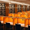 Rows of study carrels with lamps illuminated in a library against shelves of books Royalty Free Stock Photo