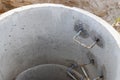 A well made of reinforced concrete rings with water at the bottom. Inside the well. Sewer well from the inside