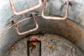 A well made of reinforced concrete rings with water at the bottom. Inside the well. Sewer well from the inside