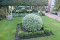 Well-maintained garden featuring topiary and decorative landscaping elements in a serene outdoor setting Royalty Free Stock Photo