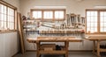 Well-organized woodworking shop with tools, workbench, and lumber, bathed in natural light Royalty Free Stock Photo