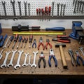A well-organized workshop bench featuring a variety of hand tools. Wrenches hang on Royalty Free Stock Photo
