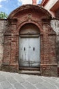 Well preserved and elaborately decorated modest ancient entrance door in Tuscany, Italy Royalty Free Stock Photo