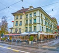 Well-preserved medieval building on Kornhausplatz square with restaurants and sidewalk cafes in Bern, Switzerland