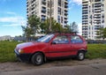 Classic small old compact city car red Fiat Uno 1.0 parked in a hot day in June, 2022 Royalty Free Stock Photo